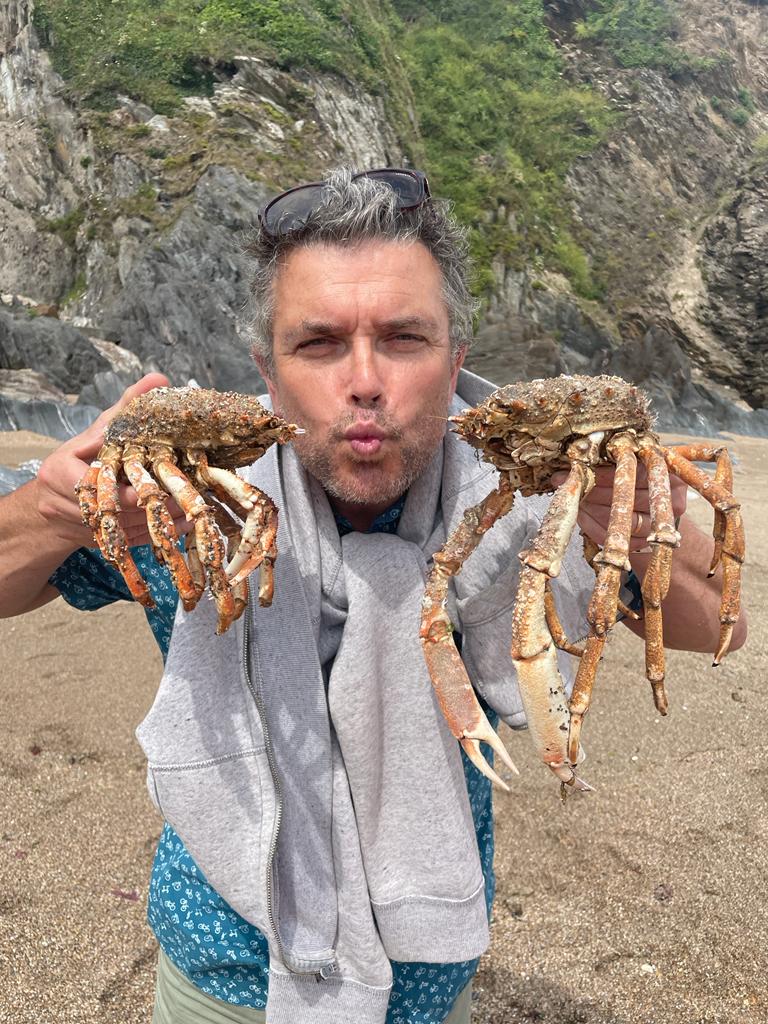 Man holding two crabs