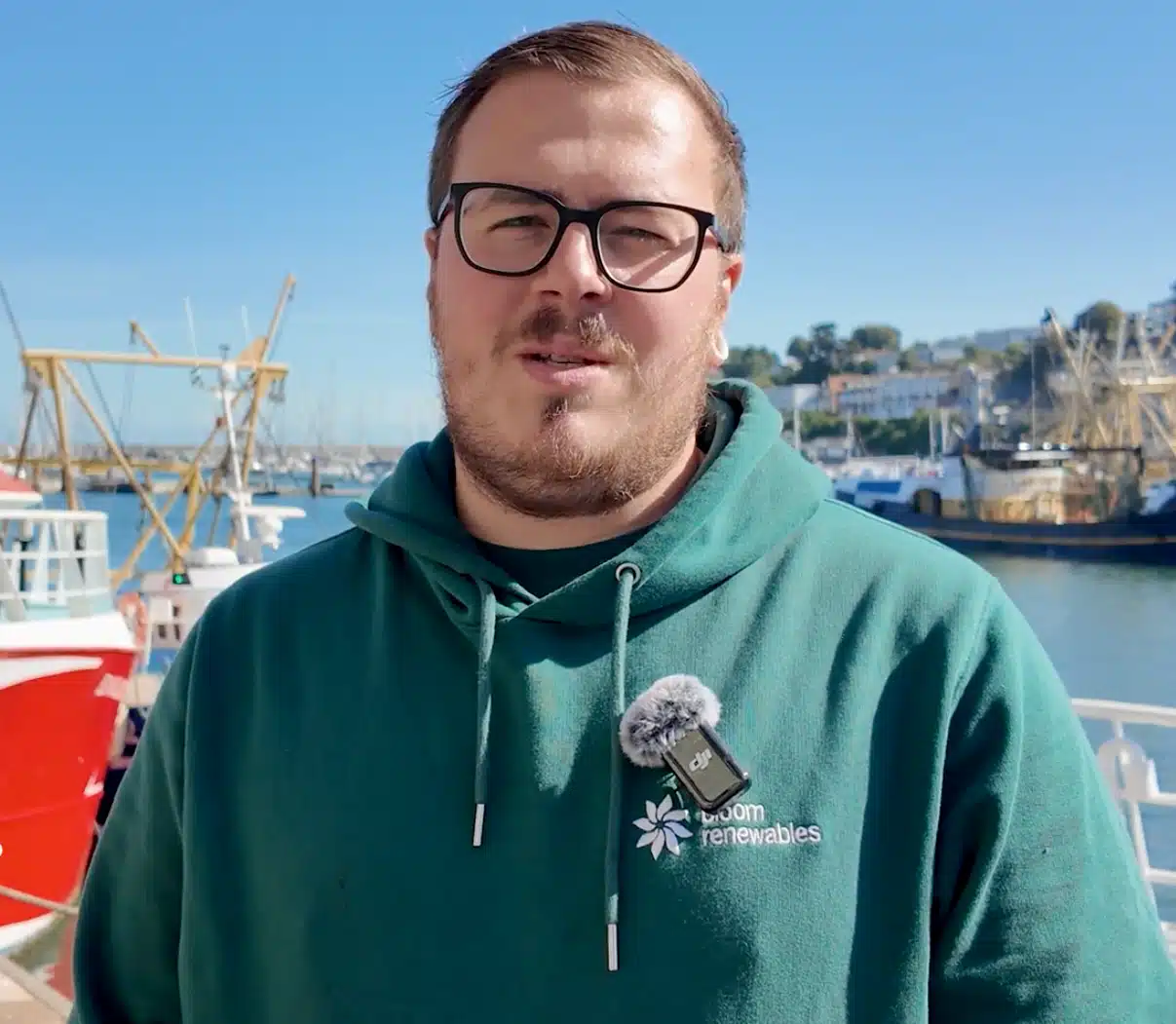 Man standing in front of fishing boat
