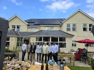 People stood outside a care home on a sunny day
