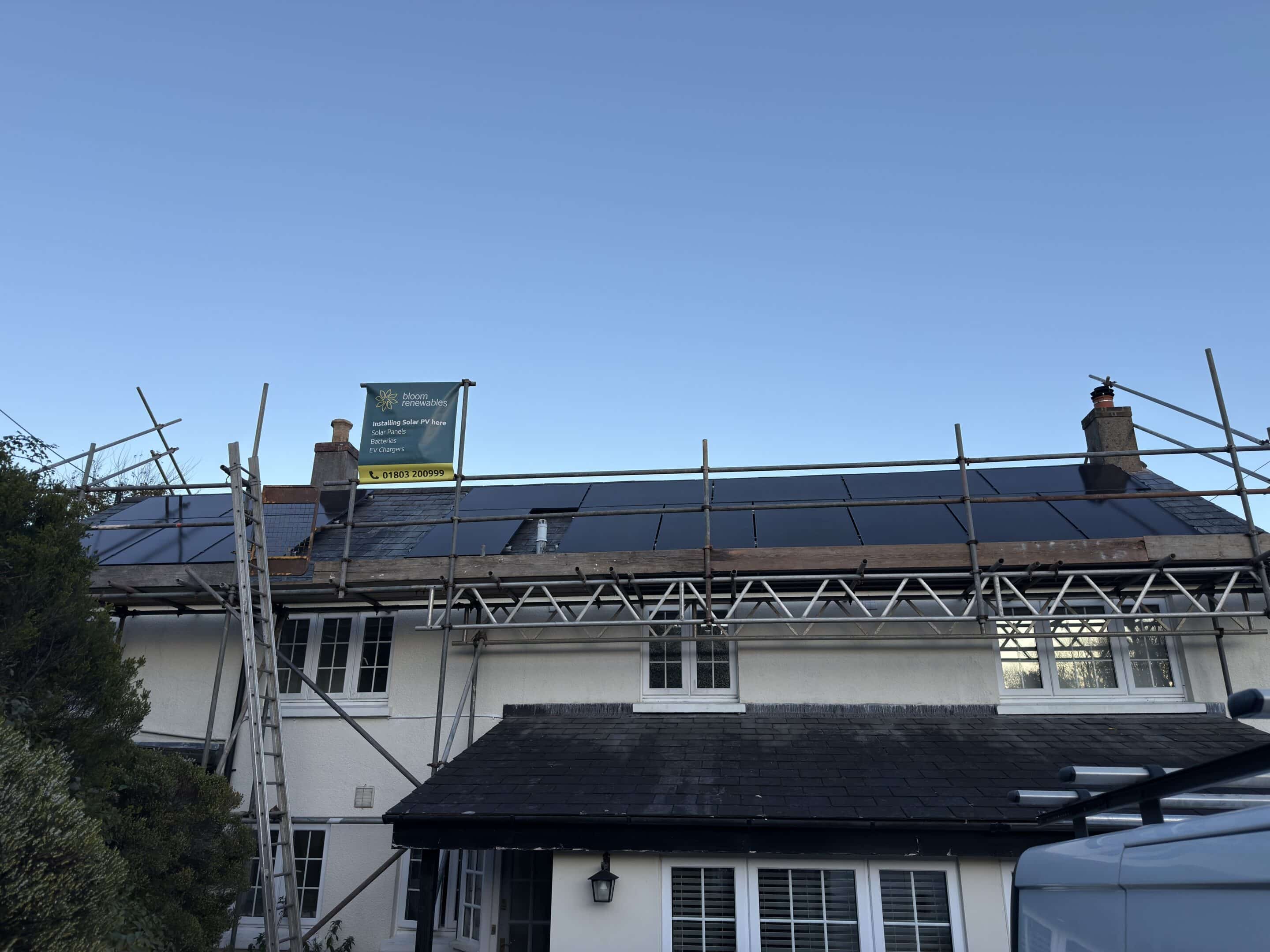 Solar panels on roof with blue sky